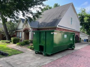 Dumpster rental in Irving TX placed outside of a house
